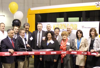 Pat Leonard of Leonard Bus Sales is seen here cutting the ribbon to officially open the new Leonard Bus Sales Type-A school bus facility in Garden City Park.