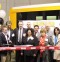 Pat Leonard of Leonard Bus Sales is seen here cutting the ribbon to officially open the new Leonard Bus Sales Type-A school bus facility in Garden City Park.